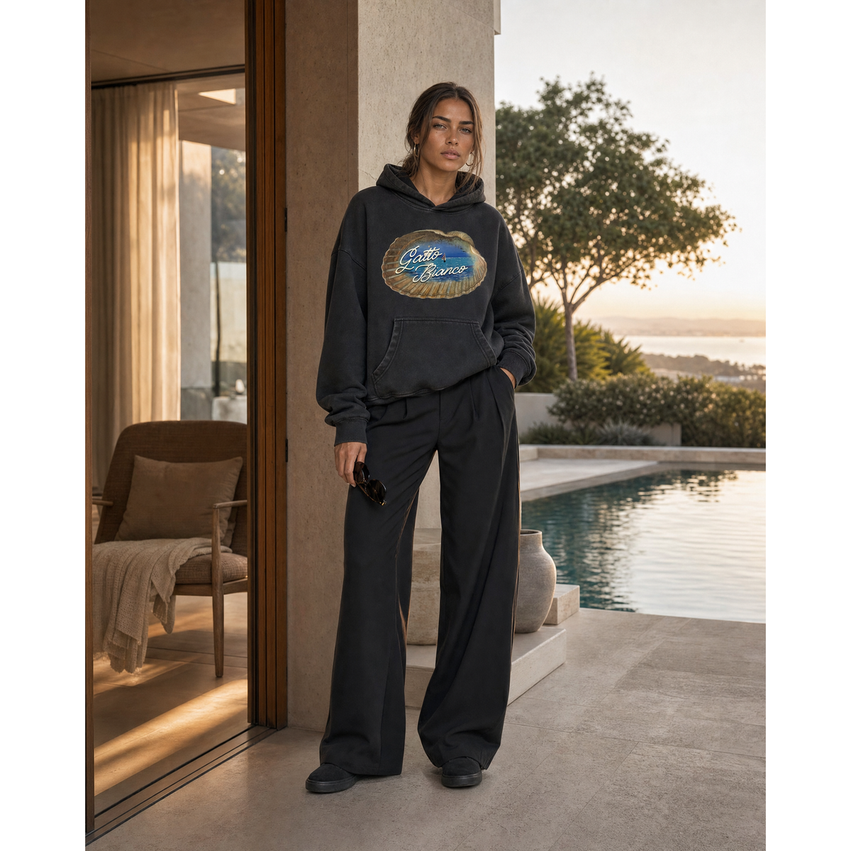 Alba Hoodie in Black — lifestyle view. Gatto Bianco Palace.